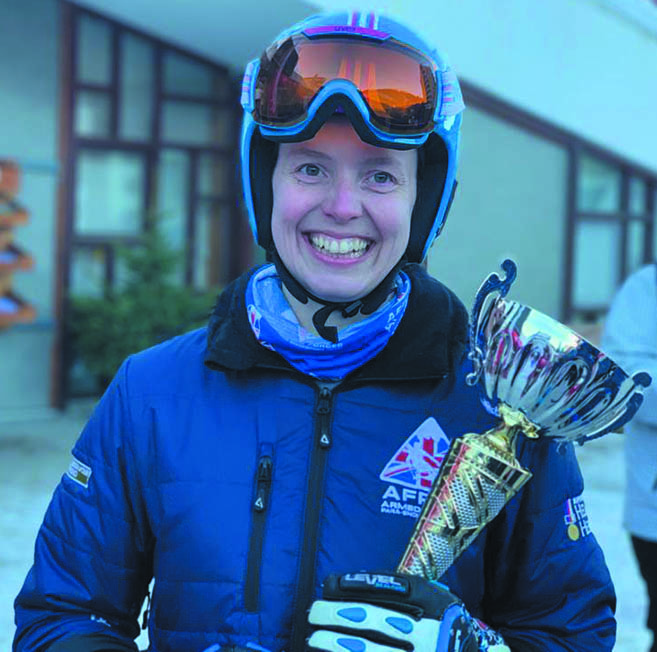 Shona holds a trophy in Skiing kit.
